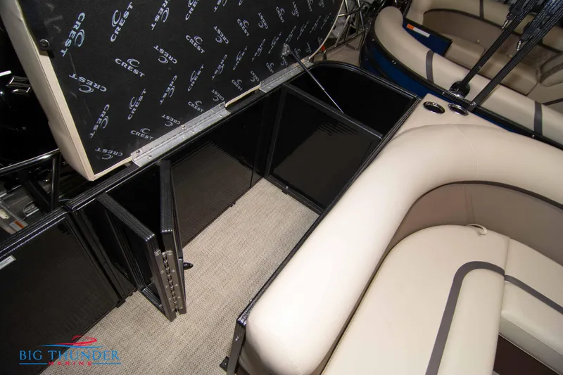 Slide: The Image of 2023 Crest Classic DLX 240 SLC boat interior storage compartments and seating. - 37
