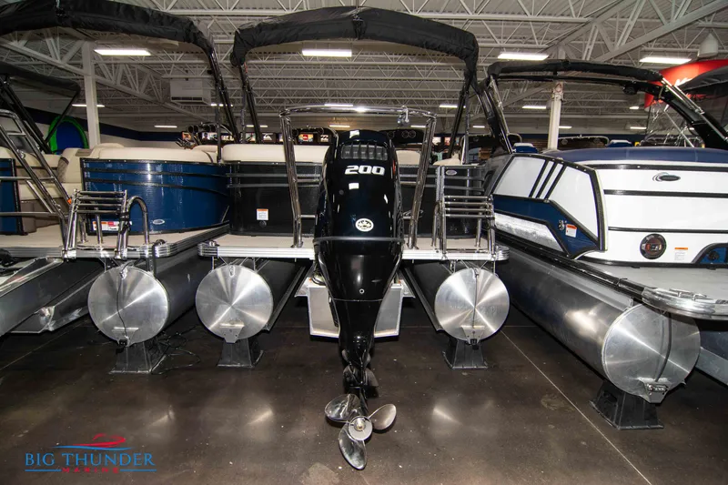 Slide: The Image of 2023 Crest Classic DLX 240 SLC pontoon boat with 200 HP engine in showroom. - 4