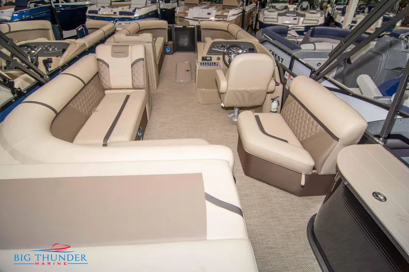 Slide: The Image of 2023 Crest Classic DLX 240 SLC pontoon boat interior with beige seating and helm. - 40