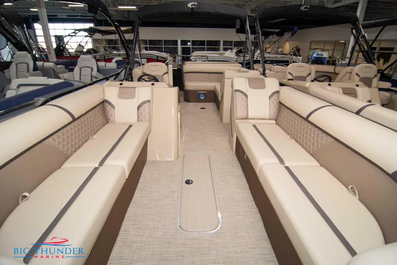 Slide: The Image of 2023 Crest Classic DLX 240 SLC pontoon boat interior with beige seating and spacious layout. - 7