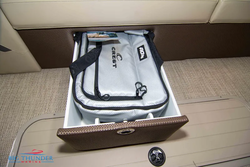 Slide: The Image of Storage compartment in 2023 Crest Classic DLX 240 SLC boat with Crest-branded bag. - 9