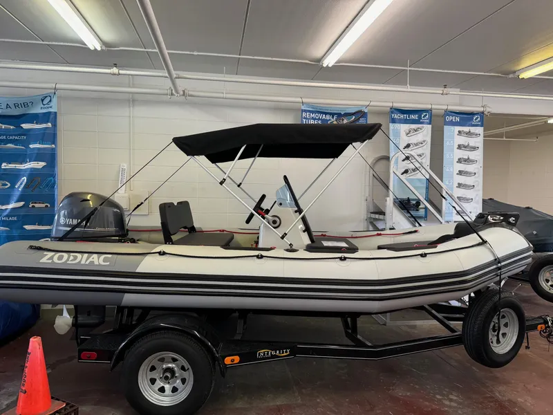 Slide: The Image of 2024 Zodiac Open 4.8 NEO boat with 70hp engine on display in showroom. - 0
