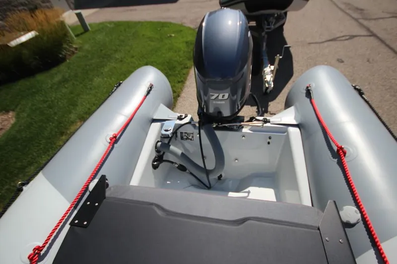 Slide: The Image of 2024 Zodiac Open 4.8 NEO inflatable boat with 70hp engine, rear view. - 12