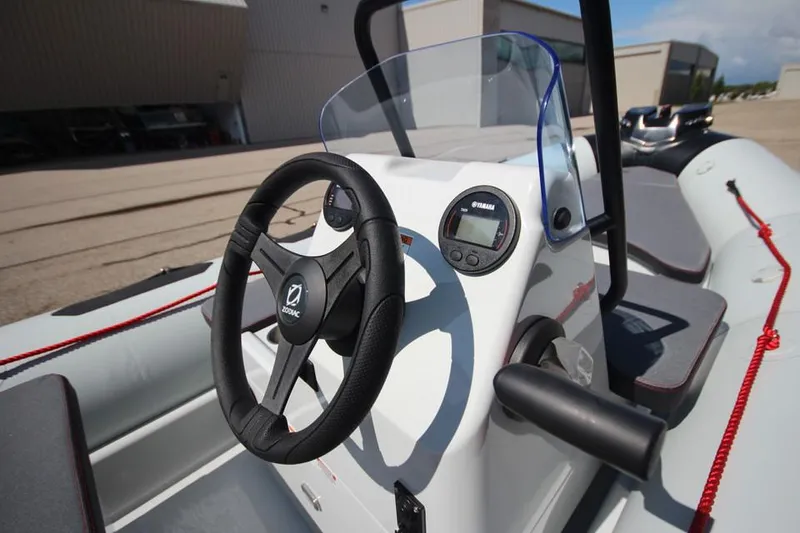 Slide: The Image of 2024 Zodiac Open 4.8 NEO 70hp boat dashboard and steering wheel. - 14