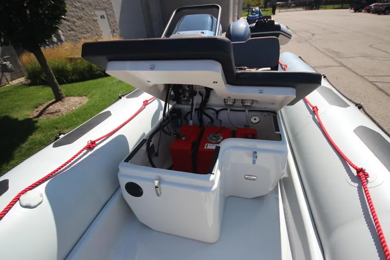 Slide: The Image of 2024 Zodiac Open 4.8 NEO 70hp boat with open storage compartment. - 15