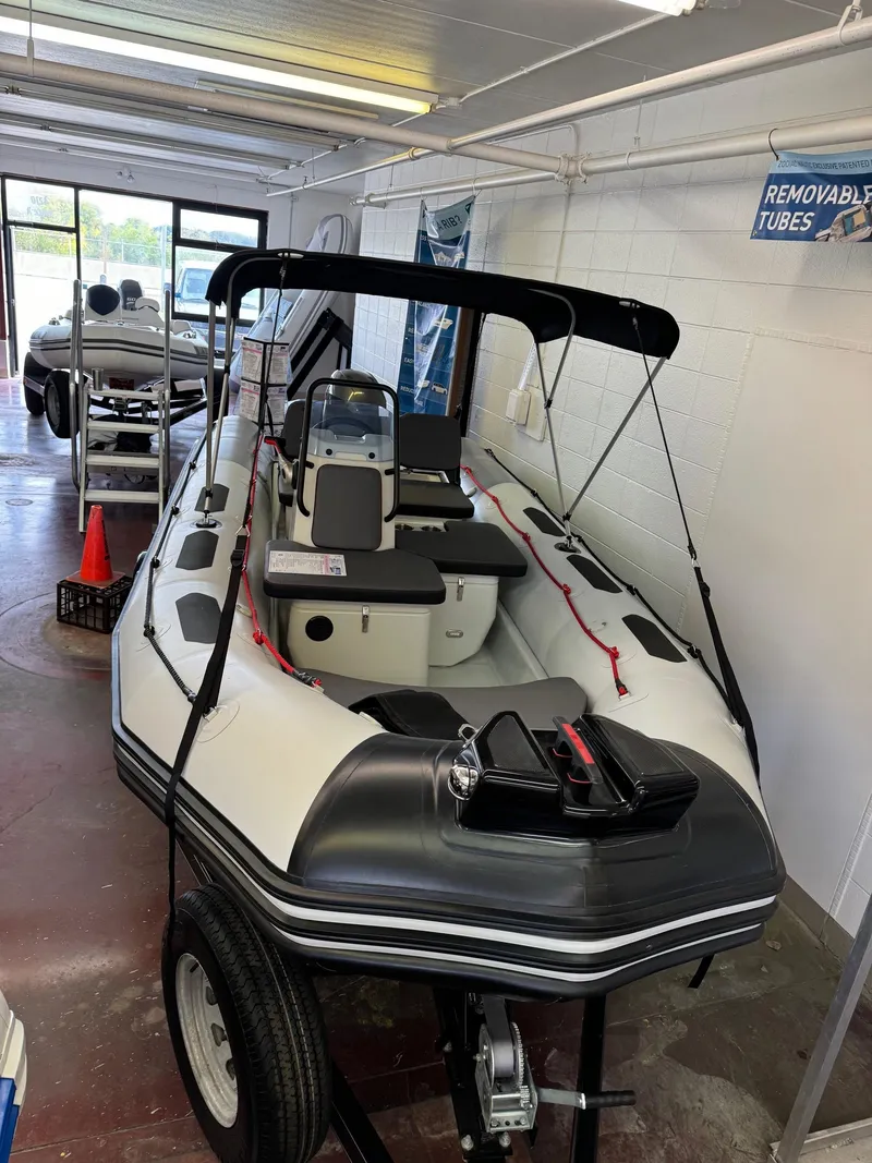 Slide: The Image of 2024 Zodiac Open 4.8 NEO boat with 70hp engine displayed indoors. - 21