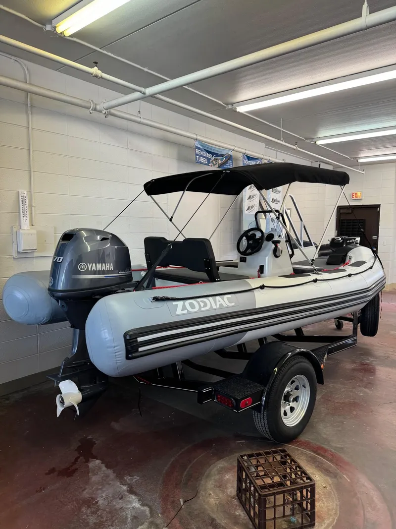 Slide: The Image of 2024 Zodiac Open 4.8 NEO boat with 70hp Yamaha engine in showroom. - 4