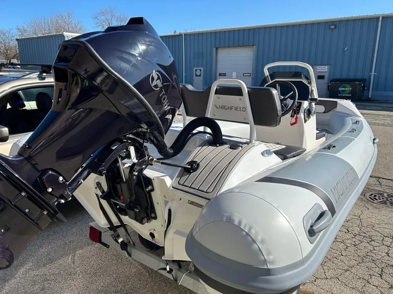 Slide: The Image of 2023 Highfield Sport 420 boat with Yamaha outboard motor in a parking lot. - 4