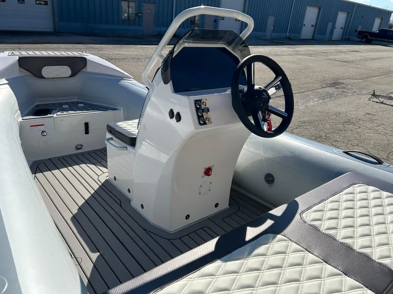 Slide: The Image of 2023 Highfield Sport 420 boat interior with steering console and cushioned seating. - 6