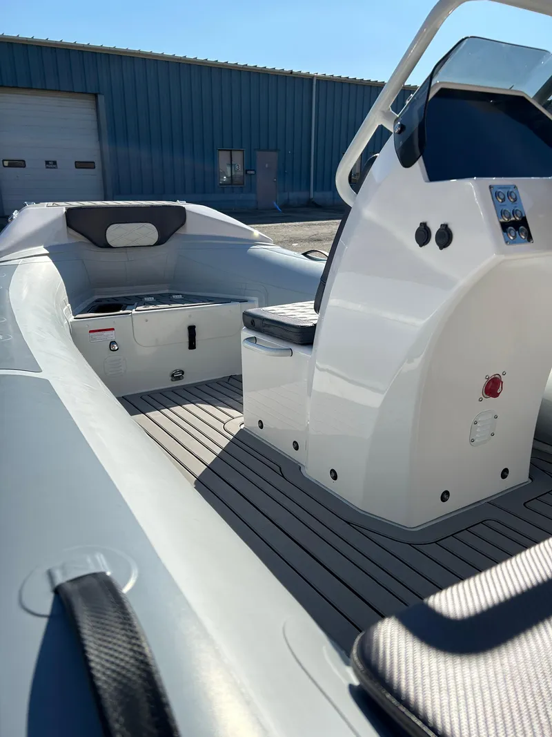 Slide: The Image of 2023 Highfield Sport 420 boat interior with steering console and seating. - 7