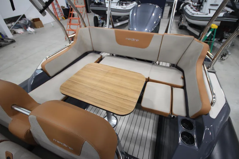 Slide: The Image of 2024 Zodiac Medline 6.8 NEO 250hp boat interior with seating and table. - 1