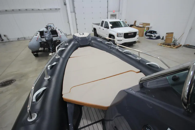 Slide: The Image of 2024 Zodiac Medline 6.8 NEO 250hp boat in stock, displayed in a showroom. - 14