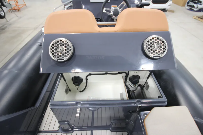 Slide: The Image of 2024 Zodiac Medline 6.8 NEO 250hp boat interior with storage compartment and speakers. - 19