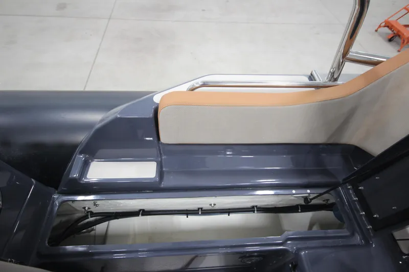Slide: The Image of 2024 Zodiac Medline 6.8 NEO 250hp boat interior detail, featuring seating and storage. - 20