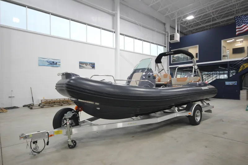 Slide: The Image of 2024 Zodiac Medline 6.8 NEO 250hp boat on trailer in showroom. - 5