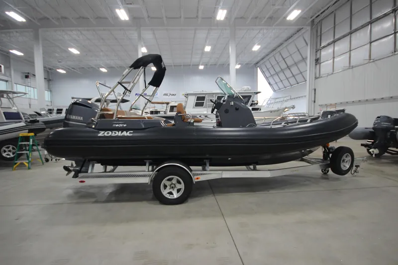 Slide: The Image of 2024 Zodiac Medline 6.8 NEO 250hp boat on trailer in showroom. - 7
