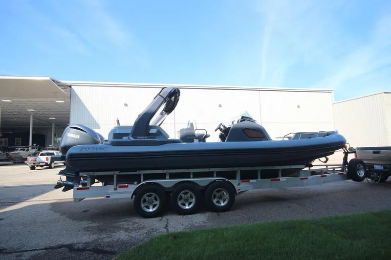 Slide: The Image of 2024 Zodiac MEDLINE 9 NEO boat on trailer, twin 300hp engines, parked outside. - 2
