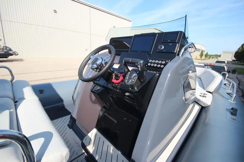Slide: The Image of 2024 Zodiac MEDLINE 9 NEO boat dashboard with modern controls and steering wheel. - 21