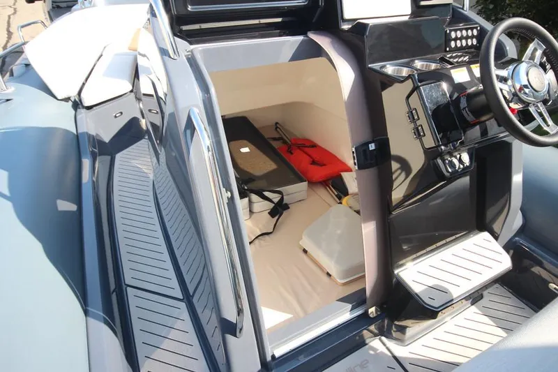 Slide: The Image of 2024 Zodiac MEDLINE 9 NEO boat interior with modern controls and storage space. - 24