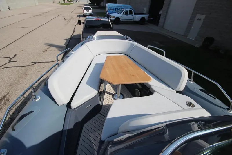 Slide: The Image of 2024 Zodiac MEDLINE 9 NEO boat with seating and table, parked on a trailer. - 27