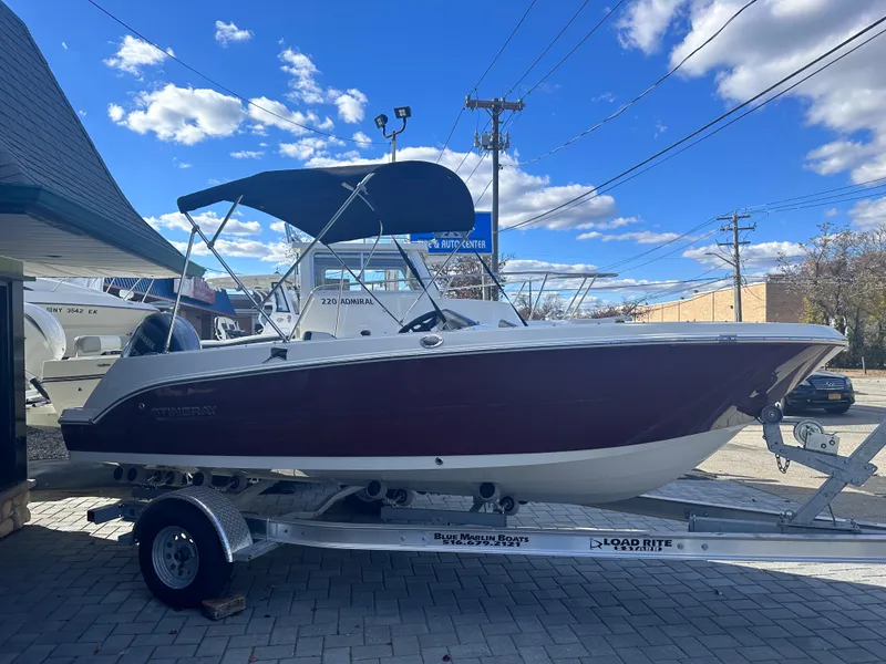 The Image of 2024 Stingray 172 SC boat on a trailer under a blue sky. - 1