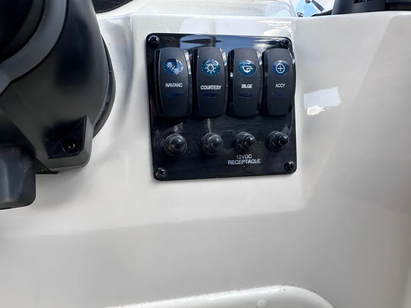Slide: The Image of Control panel of 2024 Stingray 172 SC boat with labeled switches. - 12