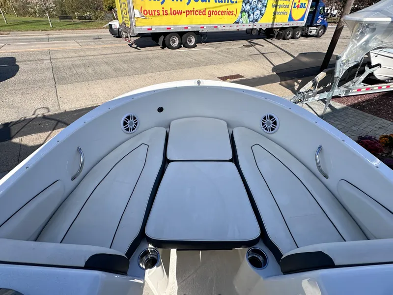 Slide: The Image of 2024 Stingray 172 SC boat interior with white seating and cup holders. - 19