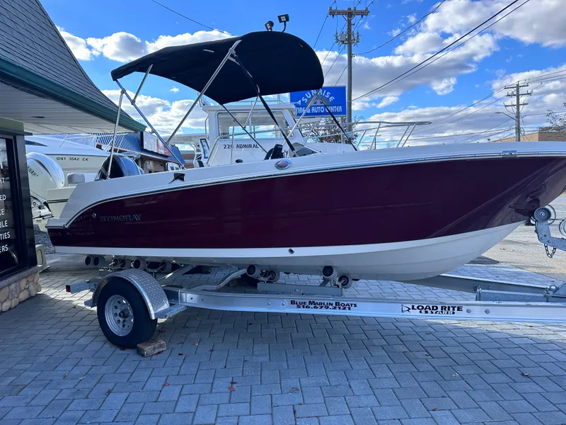 Slide: The Image of 2024 Stingray 172 SC boat on a Load Rite trailer, displayed outdoors. - 22