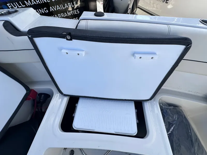 Slide: The Image of 2024 Stingray 172 SC boat storage compartment with open lid. - 6