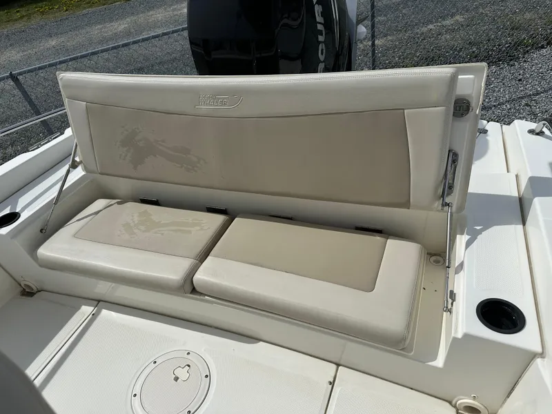 Slide: The Image of 2019 Boston Whaler 240 Dauntless boat console with steering wheel and controls. - 14