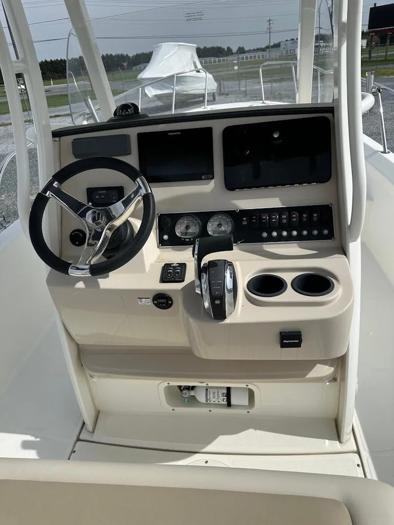 Slide: The Image of 2019 Boston Whaler 240 Dauntless boat seat with cup holders, beige upholstery. - 15