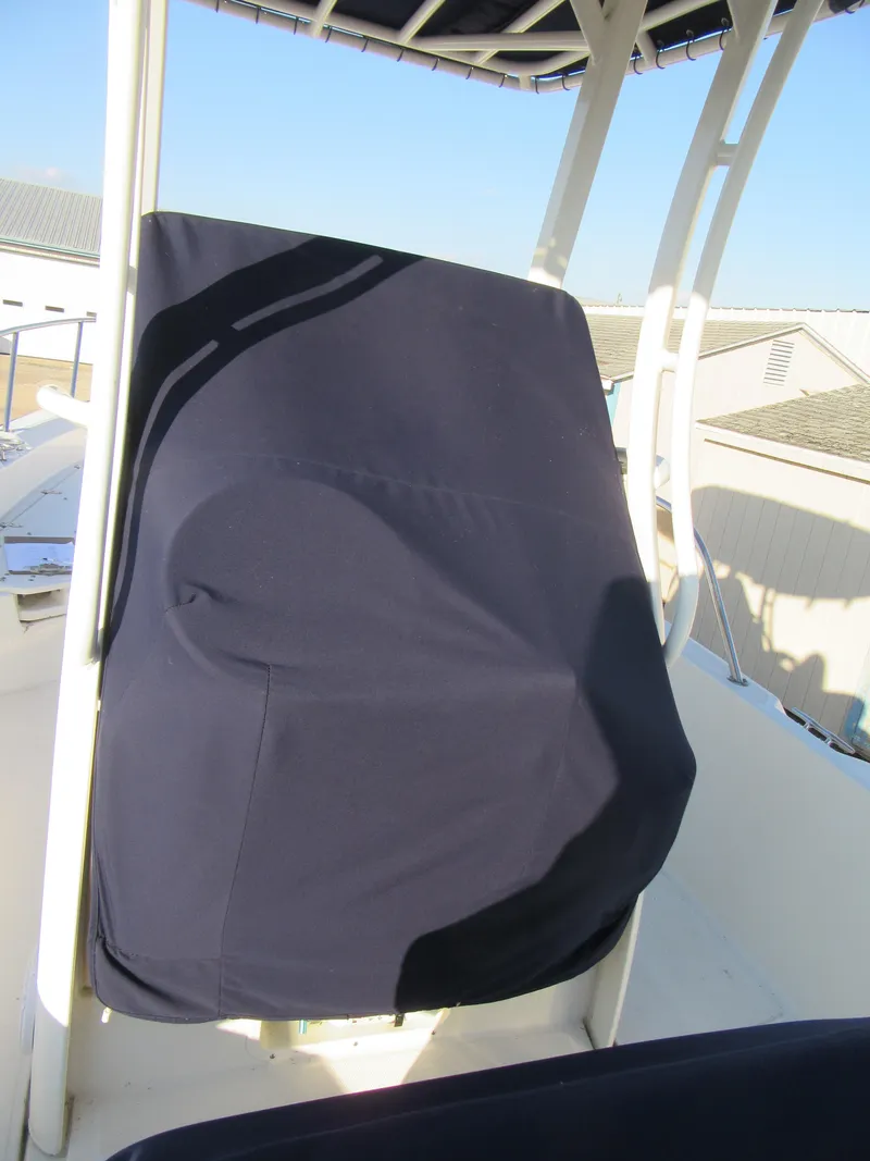 Slide: The Image of 2019 Boston Whaler 240 Dauntless boat with covered seating and Mercury outboard motor. - 9