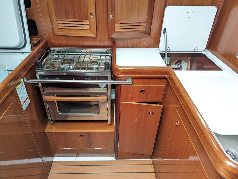Slide: The Image of 2005 Beneteau 393 yacht kitchen with stove, oven, and sink. - 13