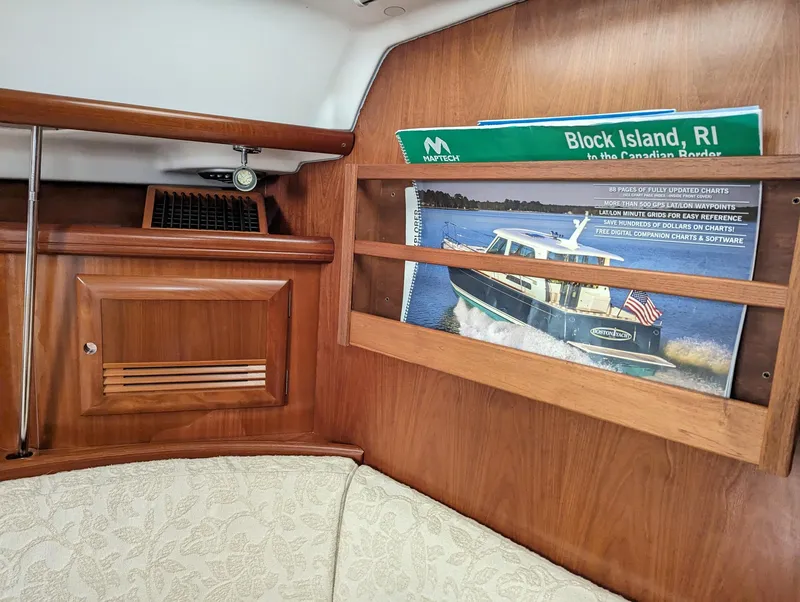 Slide: The Image of Interior of a 2005 Beneteau 393 sailboat with wooden cabinetry and nautical decor. - 18