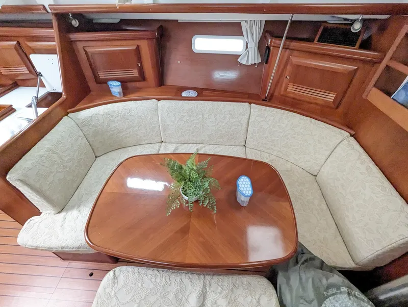 Slide: The Image of Interior of 2005 Beneteau 393 yacht with elegant dining area and wooden table. - 19