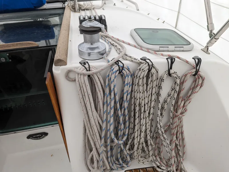 Slide: The Image of Deck of 2005 Beneteau 393 sailboat with neatly coiled ropes and winch. - 23