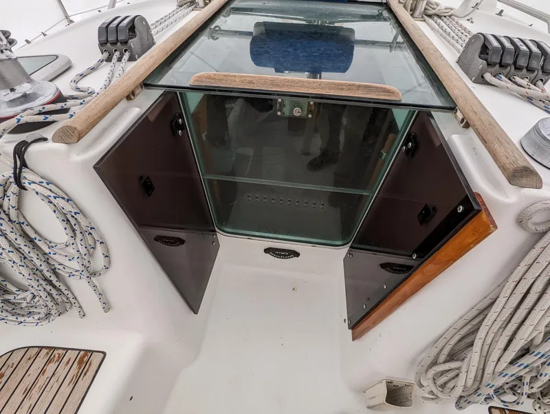 Slide: The Image of Beneteau 393 sailboat cockpit with open hatch, ropes, and winches, 2005 model. - 25