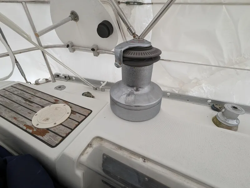 Slide: The Image of Winch on 2005 Beneteau 393 sailboat deck, featuring metal and wood elements. - 28