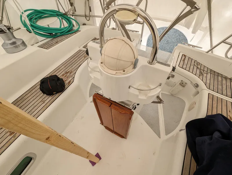Slide: The Image of Beneteau 393 sailboat cockpit, 2005 model, featuring steering wheel and wooden accents. - 29