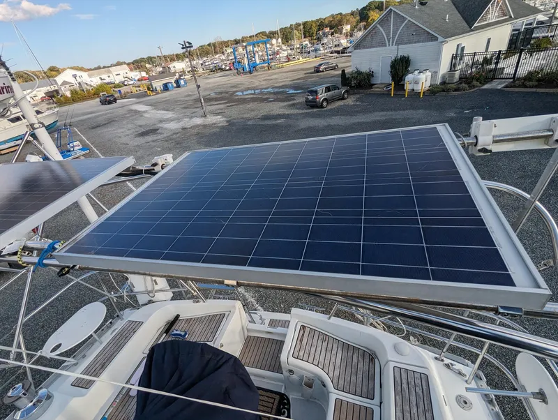 Slide: The Image of Solar panels on a 2005 Beneteau 393 sailboat in a marina setting. - 35