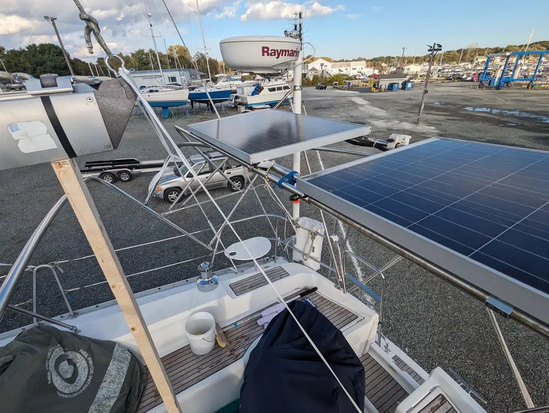 Slide: The Image of 2005 Beneteau 393 sailboat with solar panels and Raymarine equipment in a marina setting. - 36