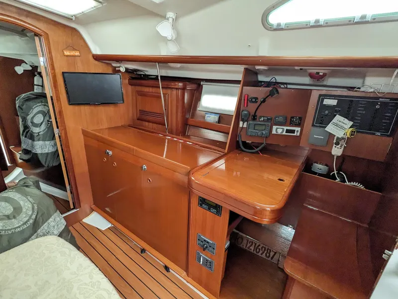 Slide: The Image of Interior of 2005 Beneteau 393 yacht with wooden cabinetry and navigation equipment. - 6