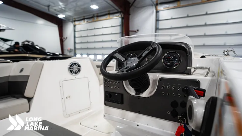 Slide: The Image of 2023 Hurricane SS188-OB boat dashboard in a marina showroom. - 11