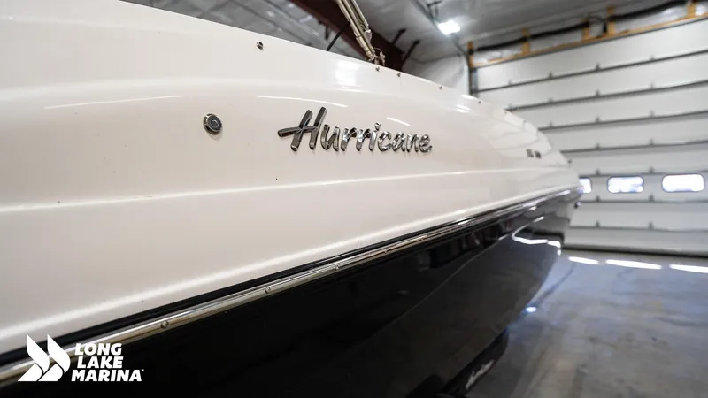 Slide: The Image of 2023 Hurricane SS188-OB boat in a marina garage, showcasing sleek design and branding. - 7