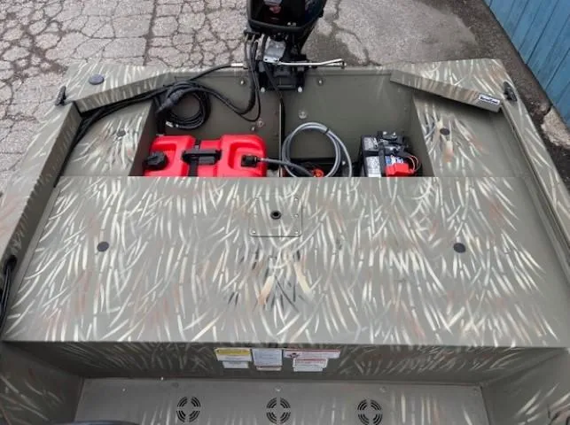 Slide: The Image of 2024 Tracker Grizzly 1648 SC boat interior with camouflage design and equipment. - 11