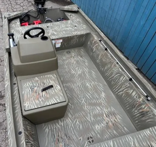 Slide: The Image of 2024 Tracker Grizzly 1648 SC boat with camouflage interior and steering console. - 7