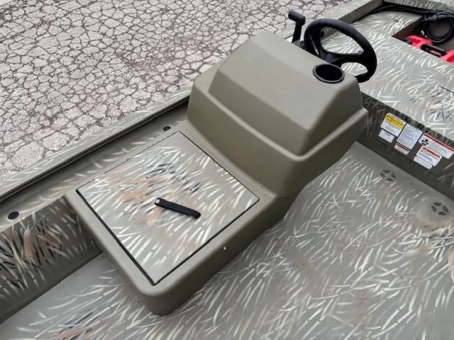 Slide: The Image of 2024 Tracker Grizzly 1648 SC boat console with camouflage pattern and steering wheel. - 8