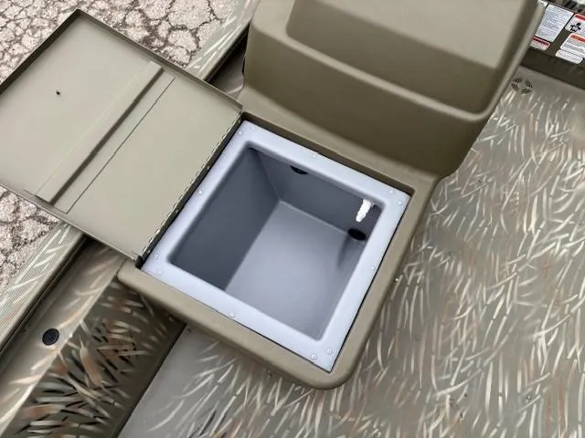 Slide: The Image of 2024 Tracker Grizzly 1648 SC boat storage compartment, open lid, camouflage pattern. - 9