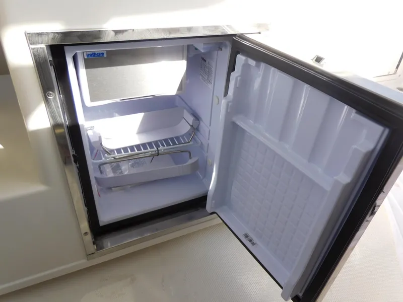Slide: The Image of Open refrigerator on 2024 Sailfish 276 DC boat. - 11