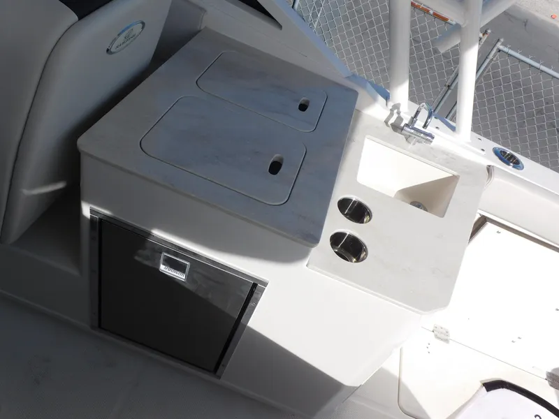 Slide: The Image of 2024 Sailfish 276 DC boat interior with sink, storage, and cup holders. - 13